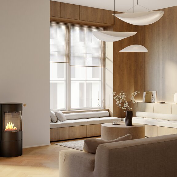 Bioethanol-Kaminofen VIVA 100 L in Schwarz in einem hellen modernen Wohnzimmer mit gemütlicher Sitzecke